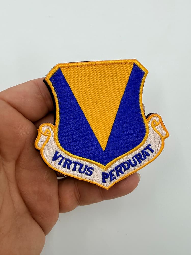 86th Airlift Wing Virtus Perdurat hook-and-loop patch, front in hand view